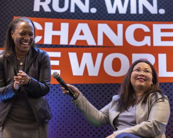 Image of Laphonza Butler and Tammy Duckworth speaking together on stage.