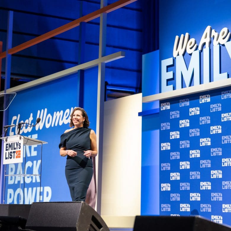 Photo of EMILYs List President Jessica Mackler walking on the stage at EMILYs List's annual gala, We Are EMILY 2026.